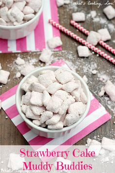 strawberry cake muddy buddies in a white bowl with pink and white striped napkin next to it