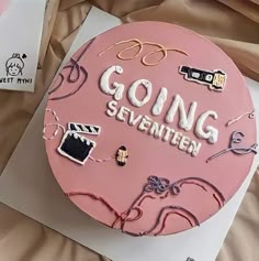 there is a pink cake with writing on it