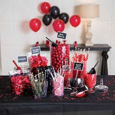 a table topped with lots of candy and lollipops on top of it