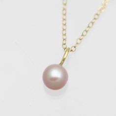 This is a handcrafted 14k yellow gold pearl pendant with a natural 7mm round AA grade cultured freshwater pink pearl. Comes on your choice of a 16 or an 18 inch 14ky gold cable chain. The artist's tag is attached at the clasp. Bail is 3.7mm inner diameter. Comes with a lifetime warranty, polishing cloth, care card, and a gift box. Available with a 5mm pearl: https://www.etsy.com/listing/927500998/pink-pearl-drop-necklace-in-14k-yellow?ref=shop_home_feat_4&frs=1 Available in rose gold: https: 14k Gold Pearl Necklace With Round Pendant, Classic Pink Pendant Necklace, Pink Round Pearl Necklace Gift, Formal Pink Pearl Charm Necklace, Pink Pearl Charm Necklace For Formal Occasions, Classic Pink Pearl Pendant Jewelry, Pink Akoya Pearl Round Necklace, Pink Pearl Pendant Necklace As Gift, Birthstone Jewelry Mothers