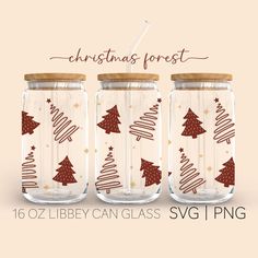 three mason jars with christmas trees on them and the words christmas forest written in red