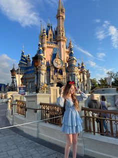 a woman standing in front of a castle