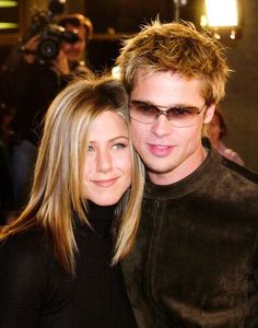 a young man and woman posing for a photo