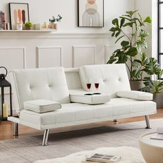 a living room with a white couch and coffee table