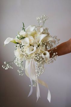 A lily bridal bouquet with calla lilies and baby’s breath. Unique Bouquets, Lily Bridal Bouquet, White Calla Lilies, Unique Bouquet, Baby S Breath, Calla Lilies, Soft Rose, Save For Later