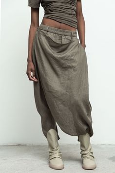 100% linen/ elastic waistband and cuff/ asymmetrical skirt overlay with button closure/ side and back pockets Helen is 5'10" size 2 wearing size S Wrapped Pants, Skirt Pant, Linen Yoga Clothes, Simple Clothes, Multiway Clothing, Japanese Fashion Women, T Shirt Upcycle, Minimalist Street Style, Wrap Pants