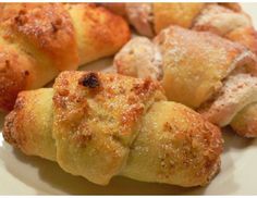 several pastries on a white plate with powdered sugar