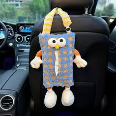 a stuffed animal hanging from the back seat of a car