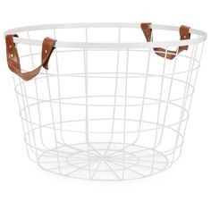 a white wire basket with brown leather handles