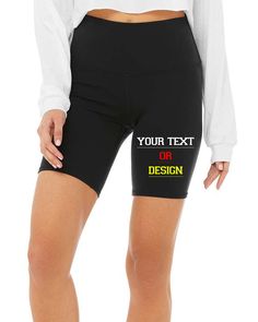 a woman wearing black shorts with the words your text or design on it