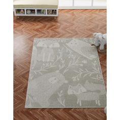 a rug with animals on it in the middle of a room