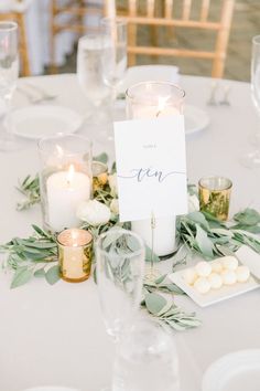 the table is set with candles and place cards