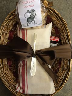 a basket filled with cookies and wrapped in brown ribbon