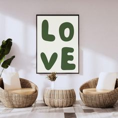 two wicker chairs in front of a love poster