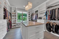 a walk in closet filled with lots of clothes