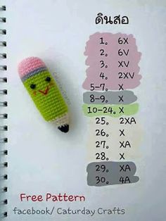 a crocheted pencil topper next to a calculator on a notebook