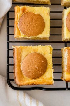 four squares of cheesecake on a cooling rack