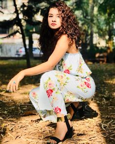 a woman sitting on the ground with her legs crossed