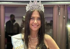 a woman wearing a tiara and smiling for the camera