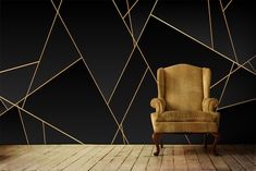 an old chair sitting in front of a black wall with gold lines on the walls