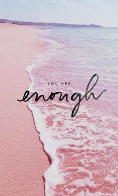 you are enough written on the sand at the beach with waves coming in to shore