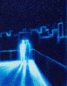 two people standing on a bridge at night with blue light coming from the top and bottom