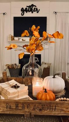 a wooden crate filled with flowers and books on top of a table next to a fireplace