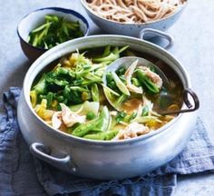 a bowl of soup with noodles and vegetables in it