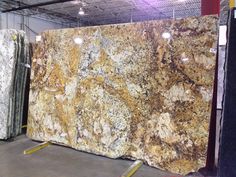 two large granites are on display in a warehouse, one is yellow and the other is brown