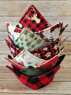 a stack of red, black and white plaid fabric napkins on top of each other