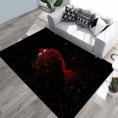 a living room area rug with red paint splattered on the floor and black background