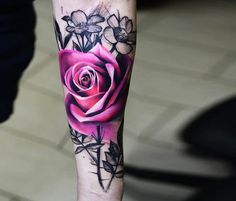 a person with a rose tattoo on their leg and the bottom half of his arm