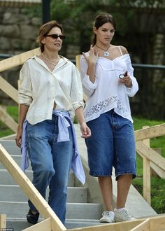 two women are walking down the stairs together