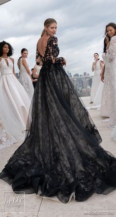 the models are all dressed in black and white gowns, with one woman looking at her