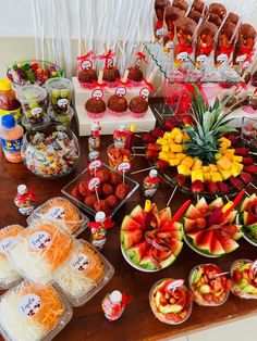 a table topped with lots of different types of fruit and snacks on top of it