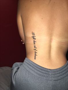 the back of a woman's lower body with writing on her left side ribcage