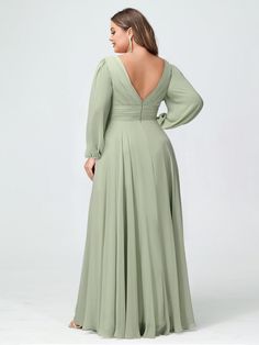 a woman in a long green dress with her back to the camera