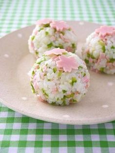 rice balls with pink and green sprinkles on a plate