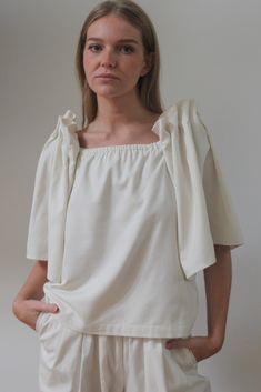 The Talu Top is a stunning blouse created from our most coveted fabric to date - our warm and structured, Silk Canvas. The Talu features dramatic open bell sleeves with intricate accordion pleat detailing, yet is balanced with a straight-forward body that can be worn tucked into favorite in-house trousers or worn over a classic dress such as our Rose Slip Dress. Made in USA Simple Tote, White Blouses, Clare V., Ribbed Knit Dress, Wide Leg Linen Pants, Double Breasted Blazer, Classic Dress, Linen Shirt, Knit Dress