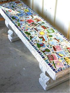 a bench made out of tiles sitting in the middle of a room next to a window