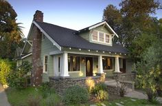 a green house with white trim and windows