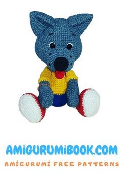 a crocheted blue and yellow stuffed animal sitting on top of a white background