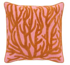 an orange and pink pillow with coral print on it's side, against a white background