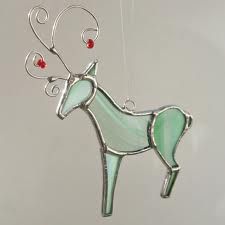 a glass reindeer ornament hanging on a wall