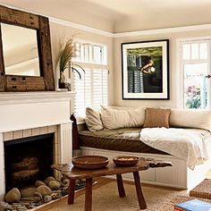 a living room filled with furniture and a fire place in front of a mirror on the wall