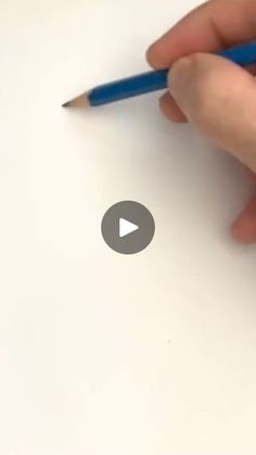 a person is writing on paper with a pencil