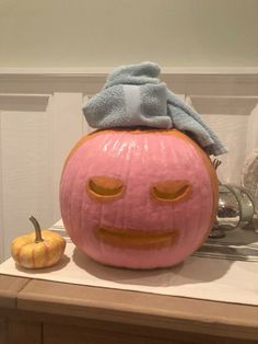 a pumpkin with a towel on top of it