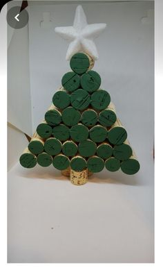 a christmas tree made out of wine corks with a white star on the top