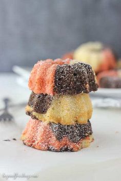 three desserts stacked on top of each other with powdered sugar and sprinkles