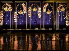 an elaborately decorated stage set with flowers and chandeliers on it's sides